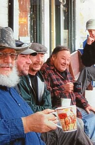 A photo of men sitting along a bench